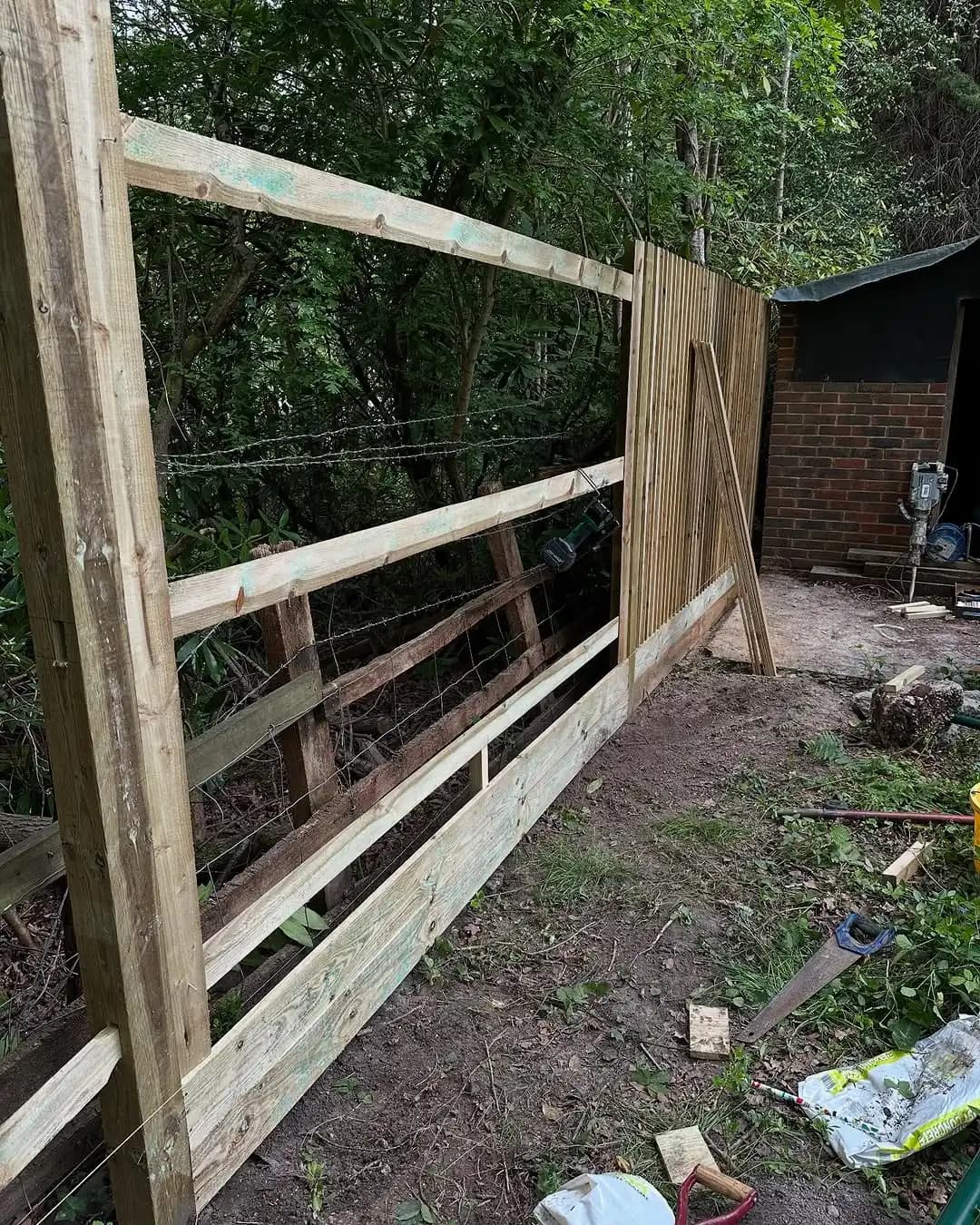 Boundary fencing installation through a wooded section of land - image 5